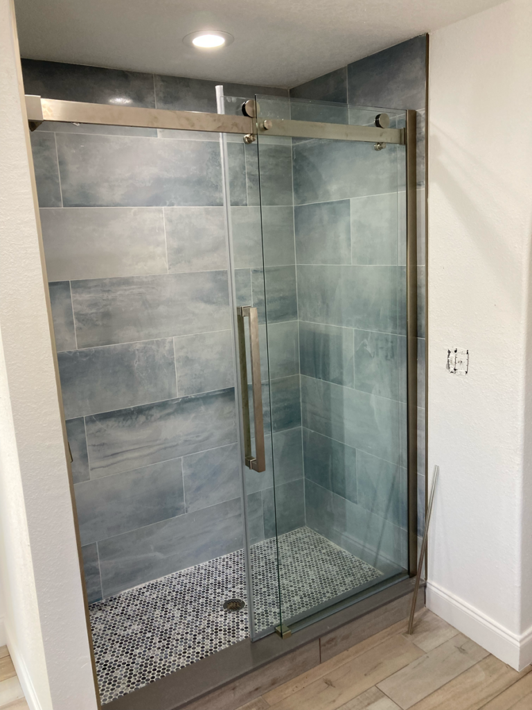 Blue Stone Tile Shower with Glass Doors in a Standing Shower | Gallery Showcase